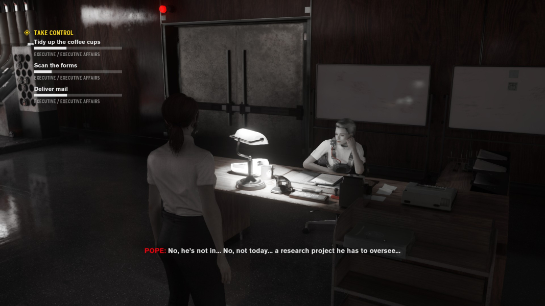 Emily Pope sits at a desk, talking to no one in particular.