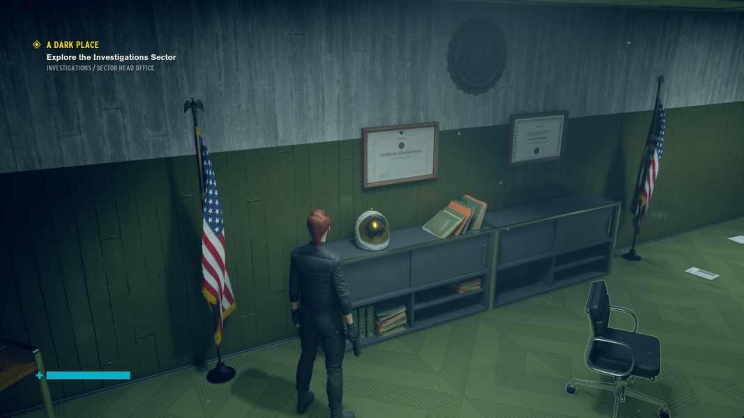 Jesse stands in front of an astronaut helmet sitting on top of a shelf.