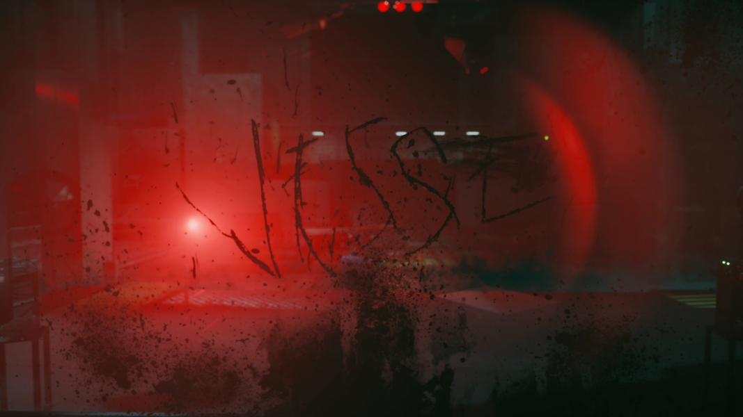 Glass backlit by red light. Jesse's name is written on it.