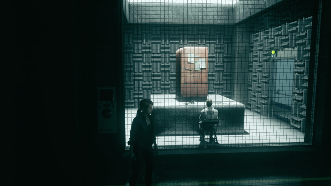 Philip sits in front of a refrigerator.