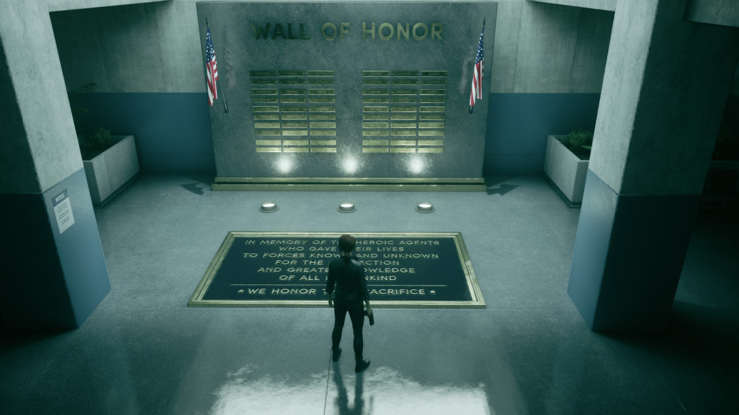 Jesse stands in front of the Wall of Honor.