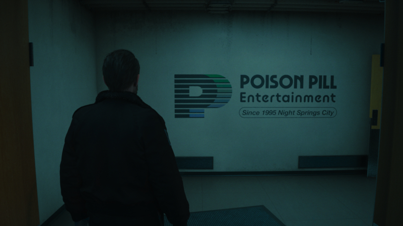 Tim looks at a Posion Pill Entertainment logo on the wall.